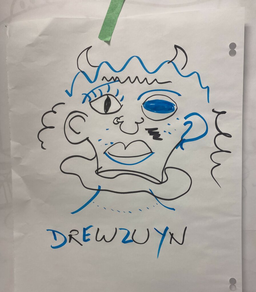 A funny face of a creature or monster drawn by two people with the name "Drewzuyn" below